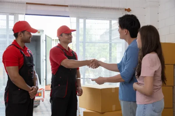 young-couple-checks-with-two-movers-unloading-boxe-2025-03-05-06-44-22-utc (1)